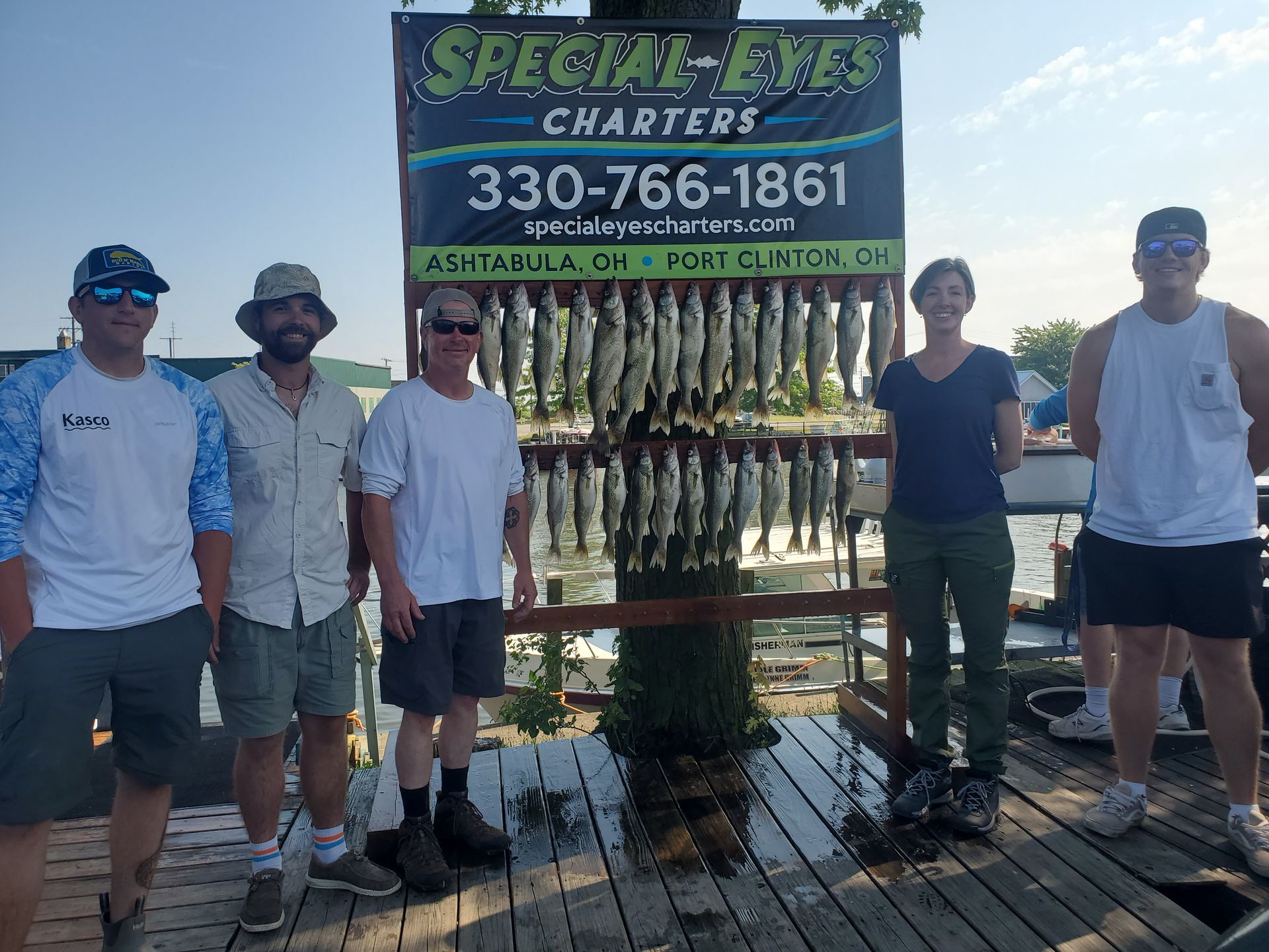 A group of people standing in front of a sign that says special eyes charters