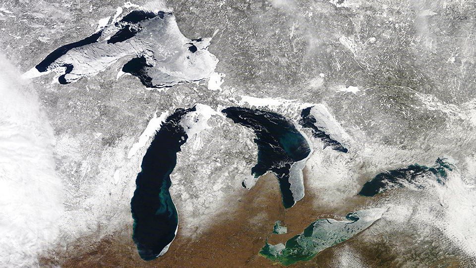 An aerial view of the great lakes covered in snow