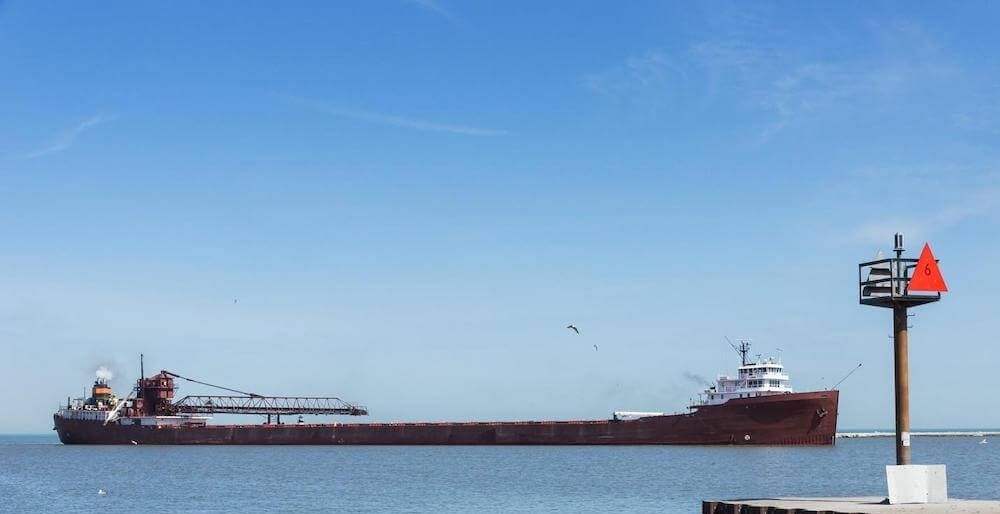 A large ship is floating on top of a body of water.
