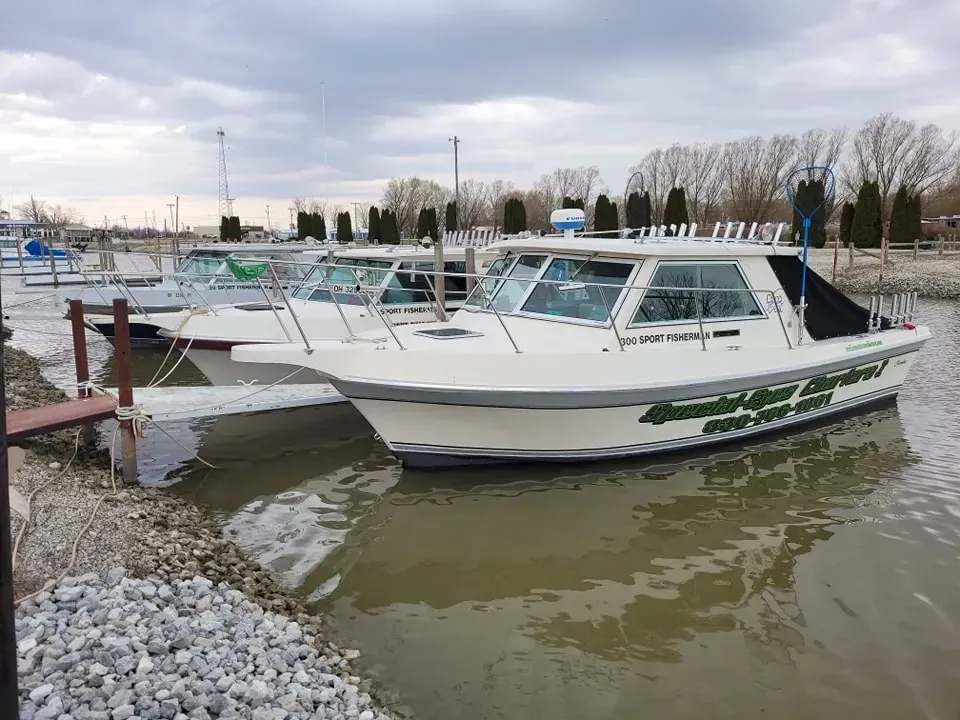 A boat is docked in a marina next to a dock.