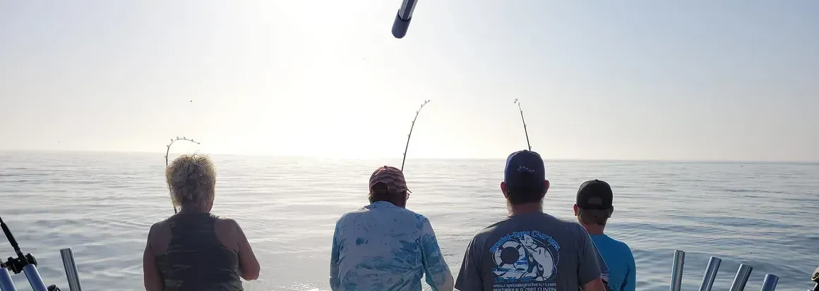 A group of people are fishing in the ocean.