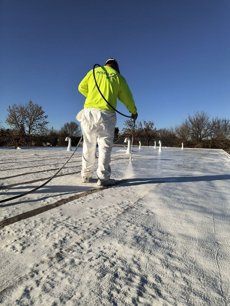 Person in a neon jacket walking on a snowy path under a clear blue sky.
