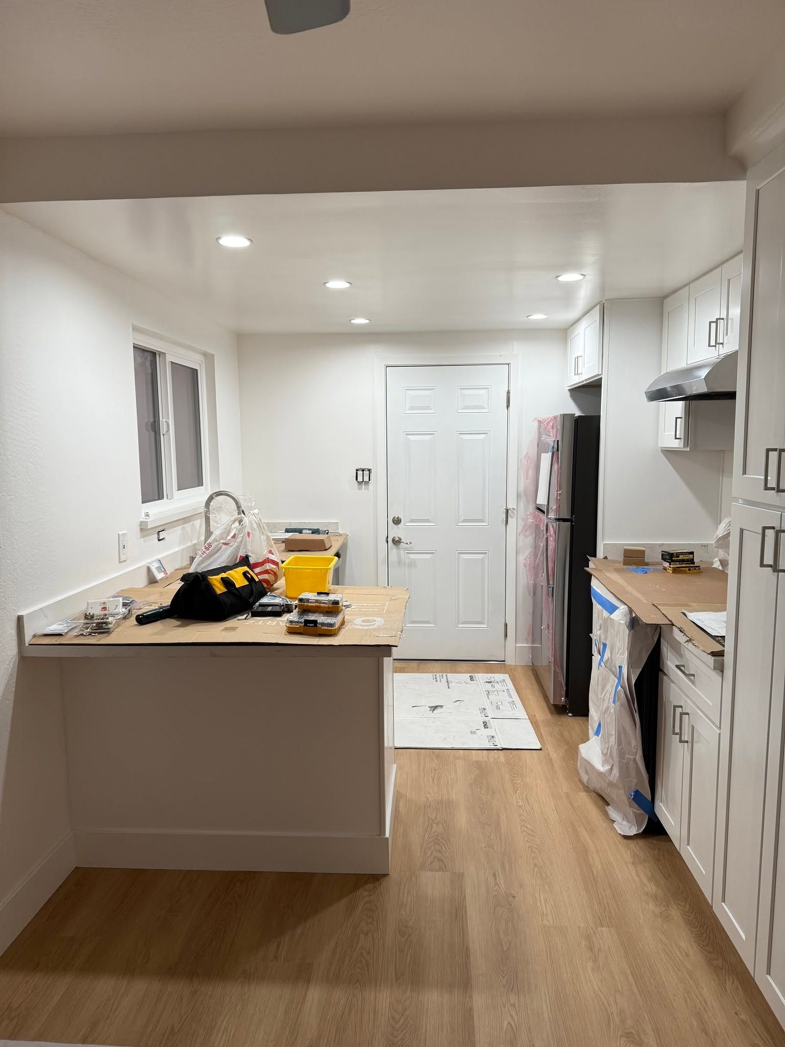 Modern kitchen with wood cabinets, stainless steel appliances, and island.