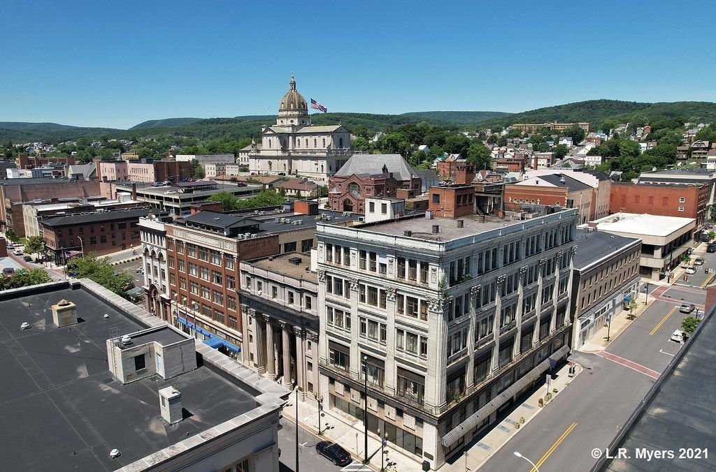 An aerial view of a city with a large building in the foreground