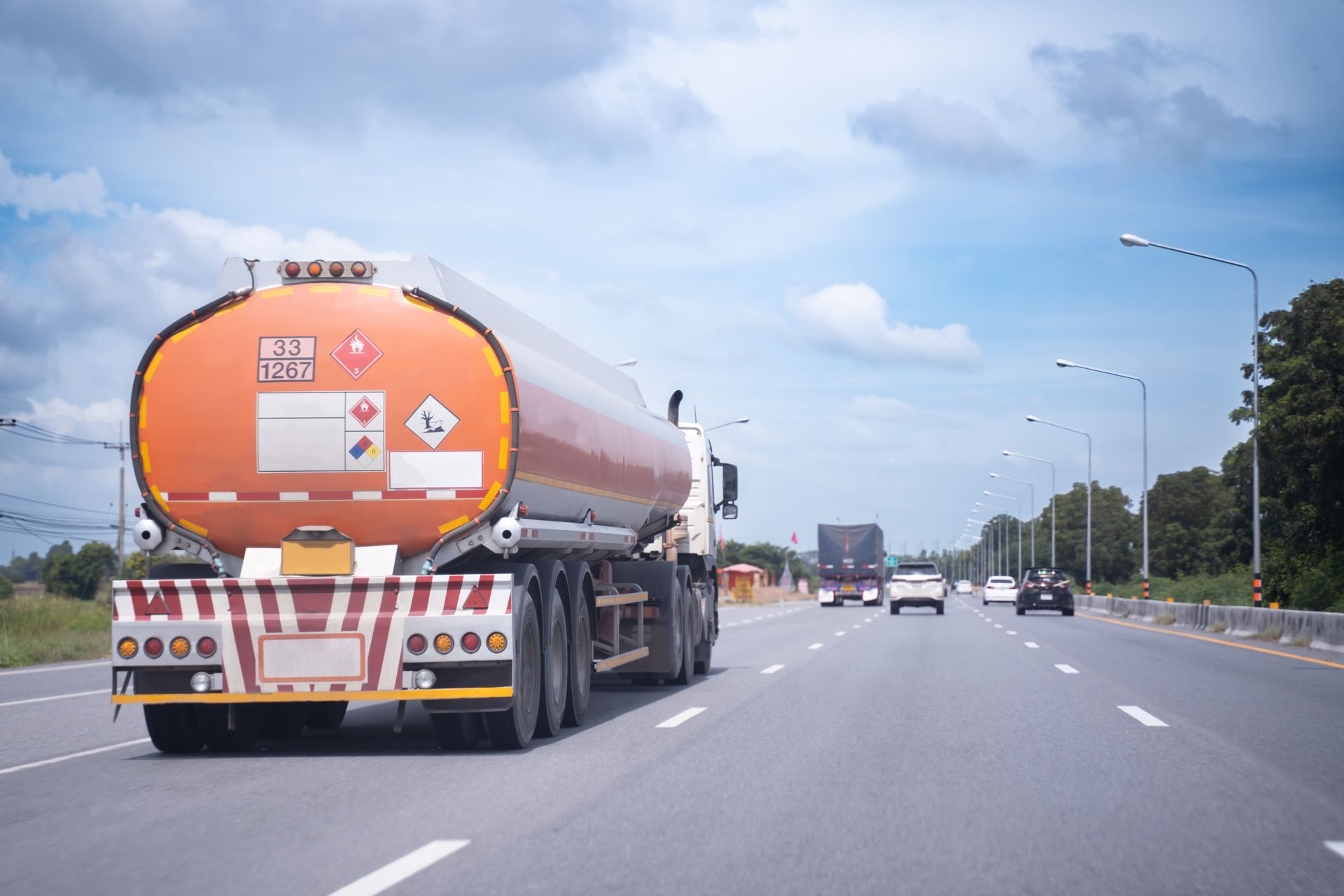 A tanker truck is driving down a highway.