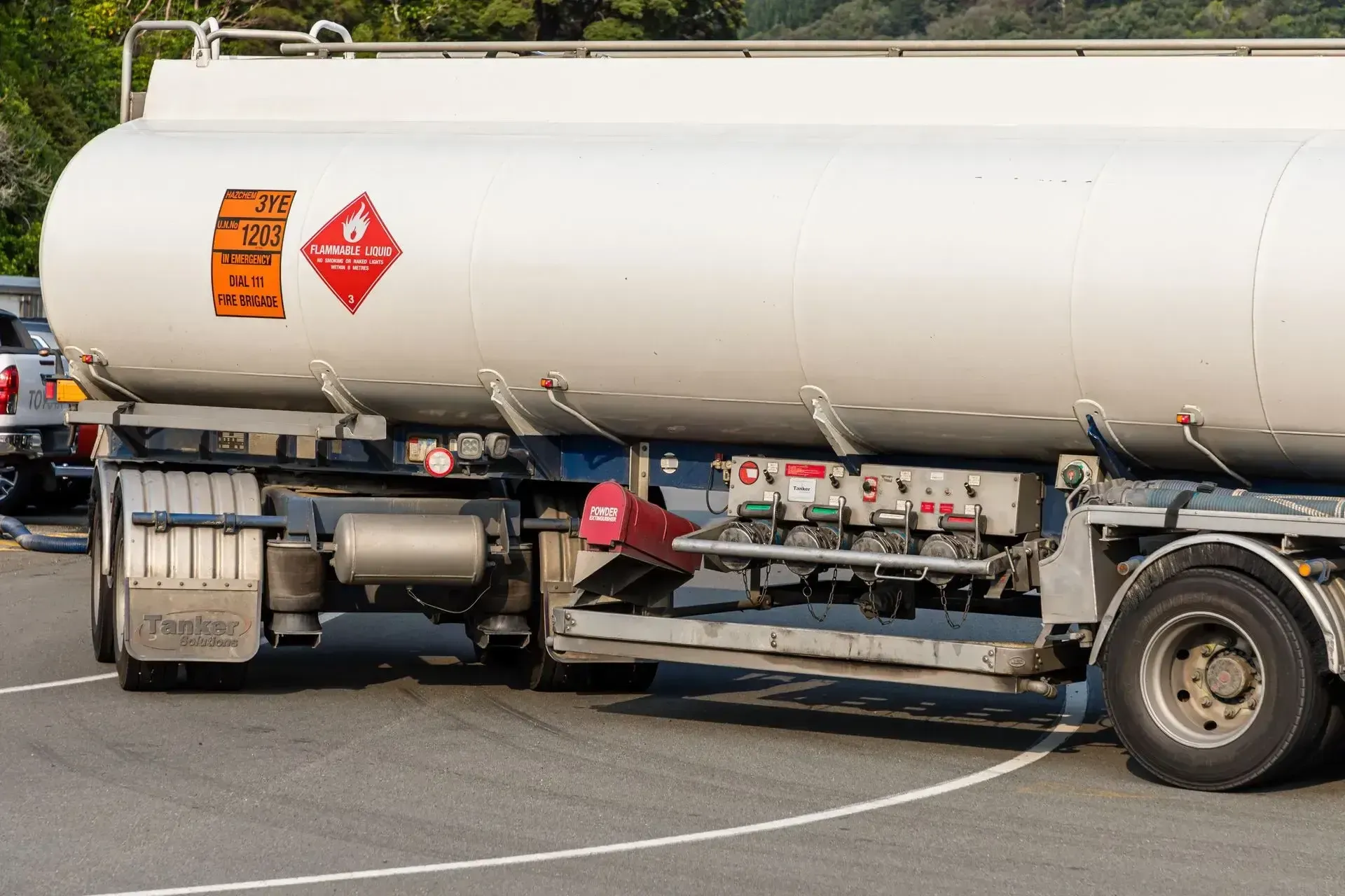 A tanker truck is parked in a parking lot.