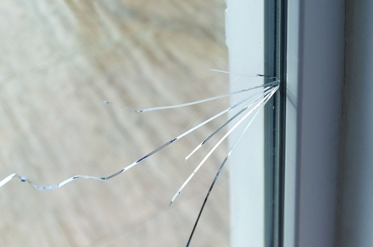 A close up of a broken glass window.