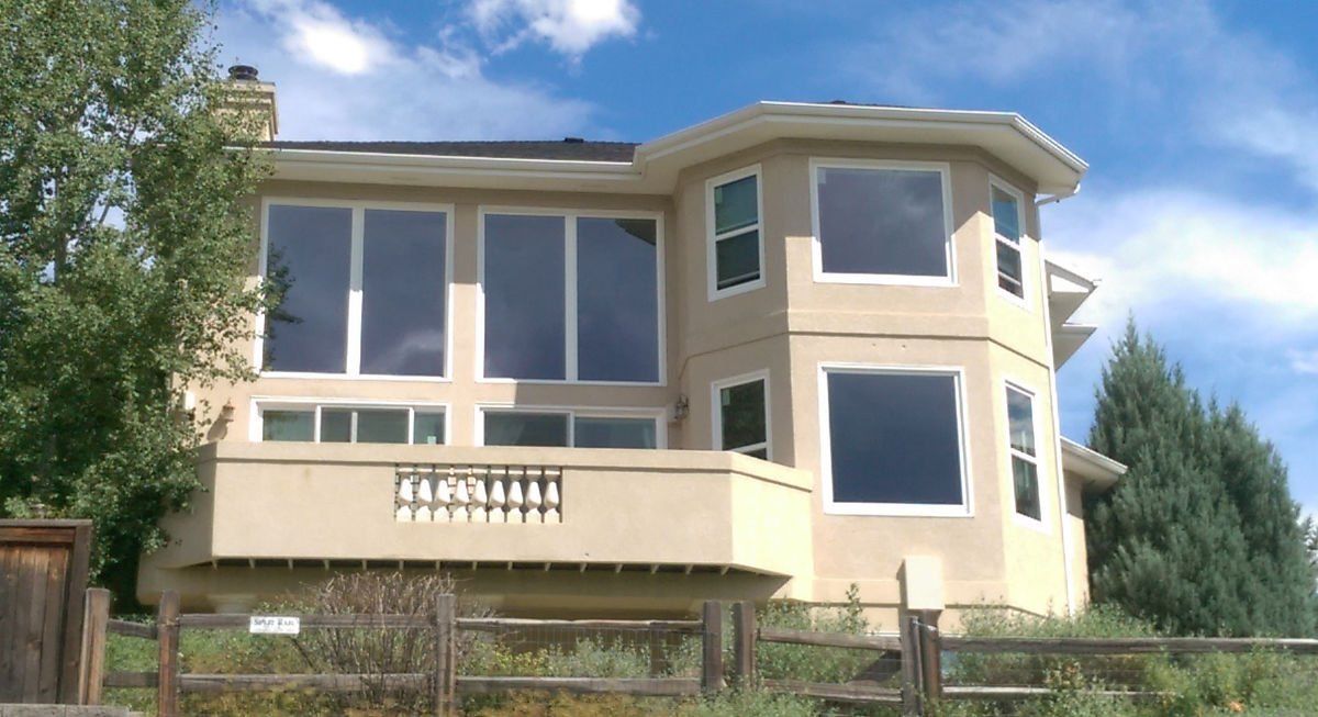 A large house with a wooden fence in front of it