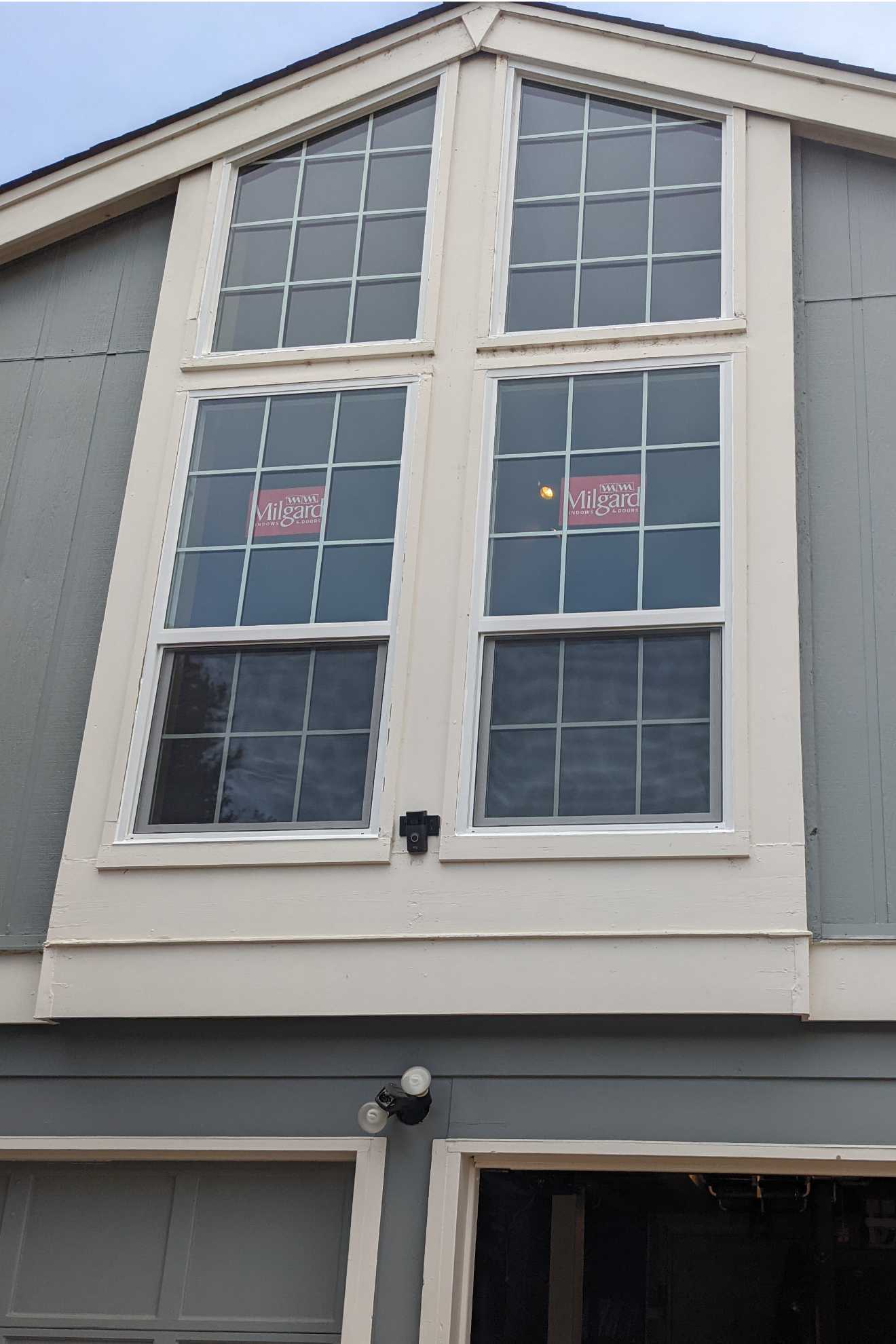 A house with a lot of windows and a garage