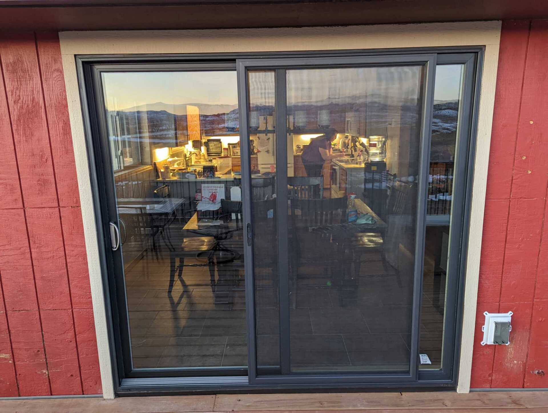 A sliding glass door leading to a deck in a house.