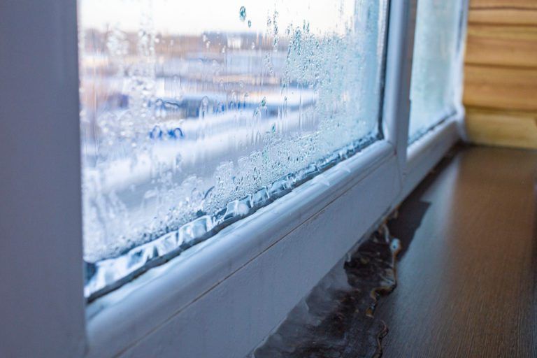 A close up of a window with water drops on it.