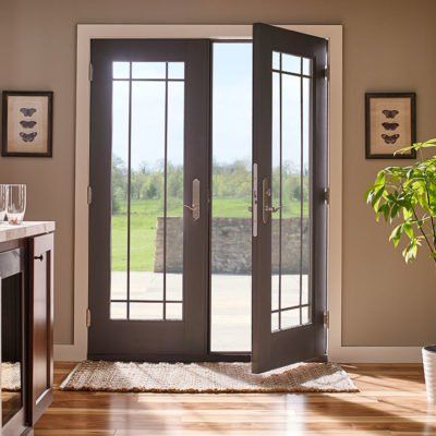 A pair of french doors are open in a kitchen.
