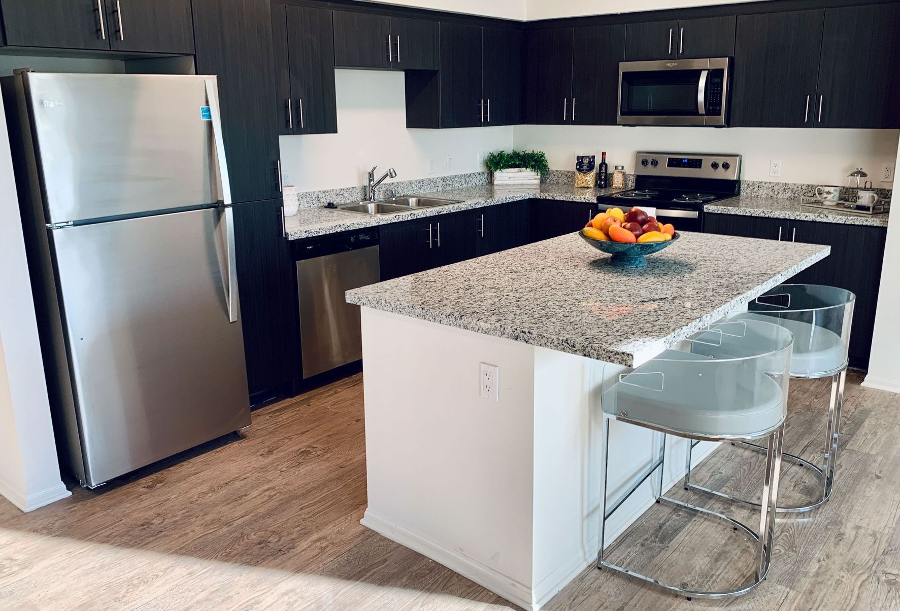 a kitchen with stainless steel appliances and granite counter tops
