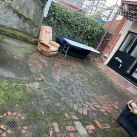 After: Clean brick courtyard after weed removal and surface tidy-up in North Dunedin.