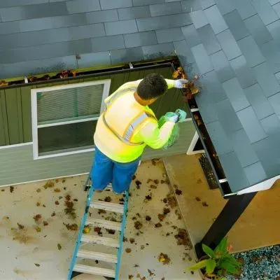 Gutter work on a Dunedin home shows the type of job that affects gutter cleaning costs for single-storey homes.
