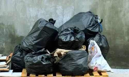 Organised rubbish bags ready for collection in Dunedin, showing responsible waste handling.
