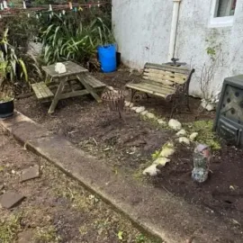 After: Garden bed and outdoor area tidied beside a residential property.