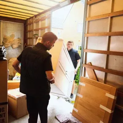 Team loading items on to a trailer during a waste collection job in Dunedin, reflecting typical rubbish removal costs.