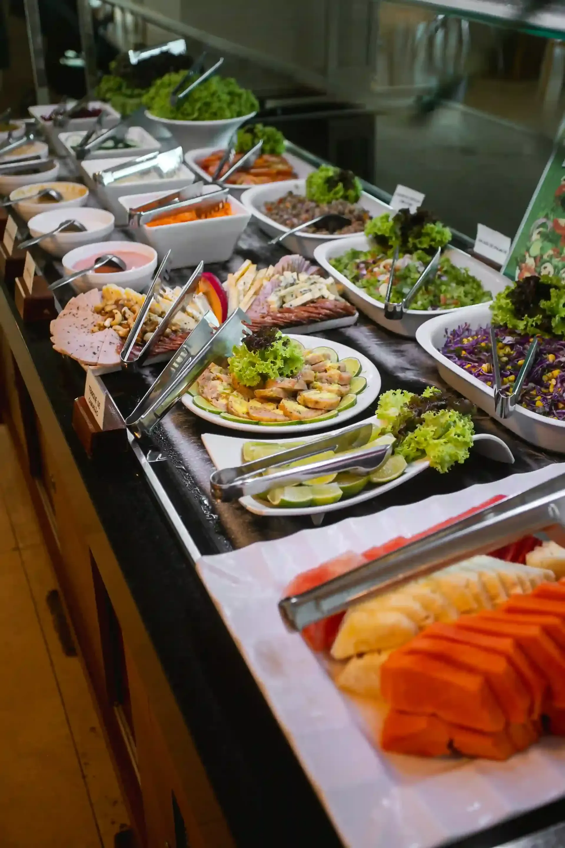 Há muitos tipos diferentes de comida na mesa do bufê.-Hotel-Praia-Dourada-Maragogi-Park