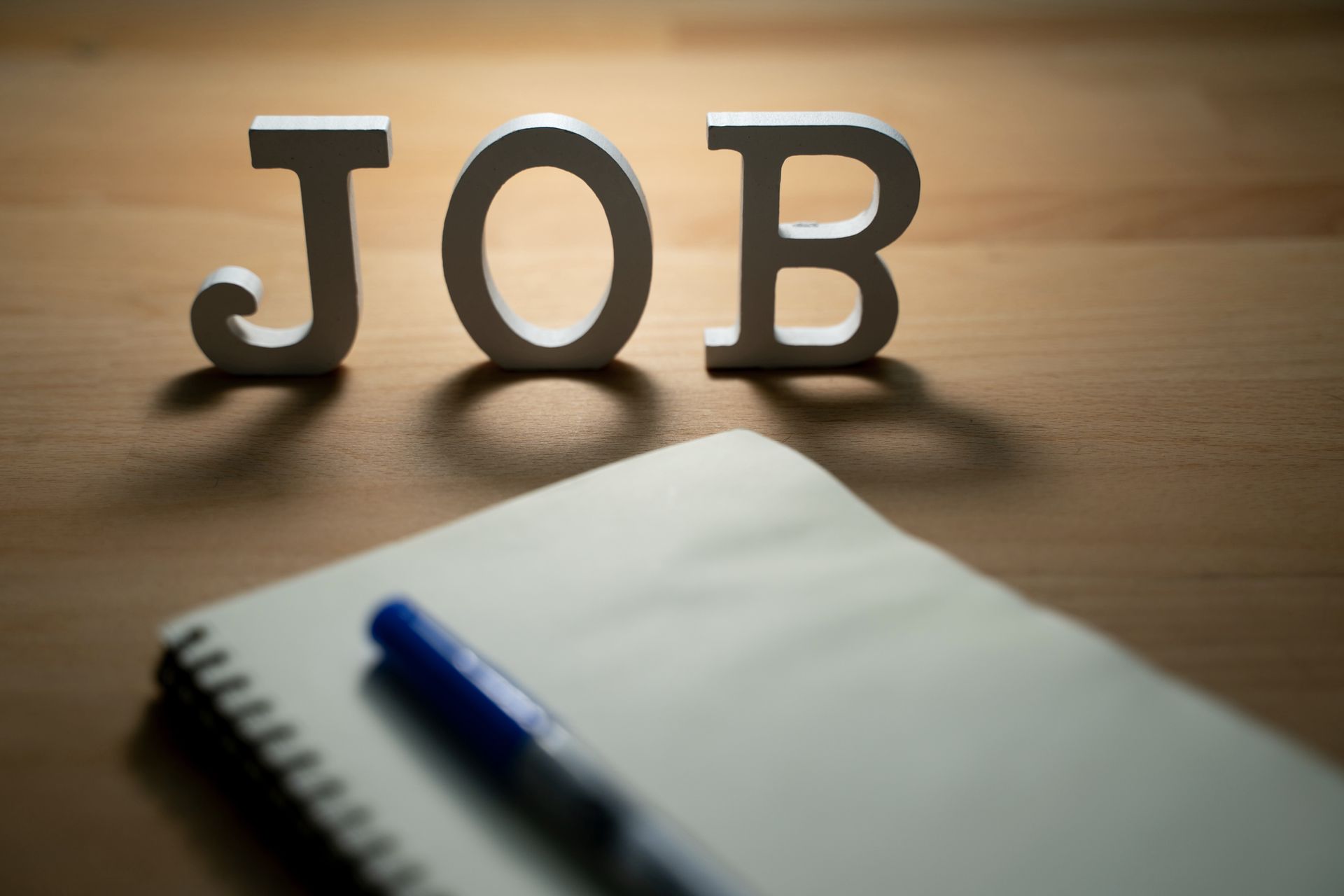 Wooden cubes spell “Jobs” with a blurred background, representing the job vacancy concept. Wooden cubes spell “Jobs” with a blurred background, representing the job vacancy concept.