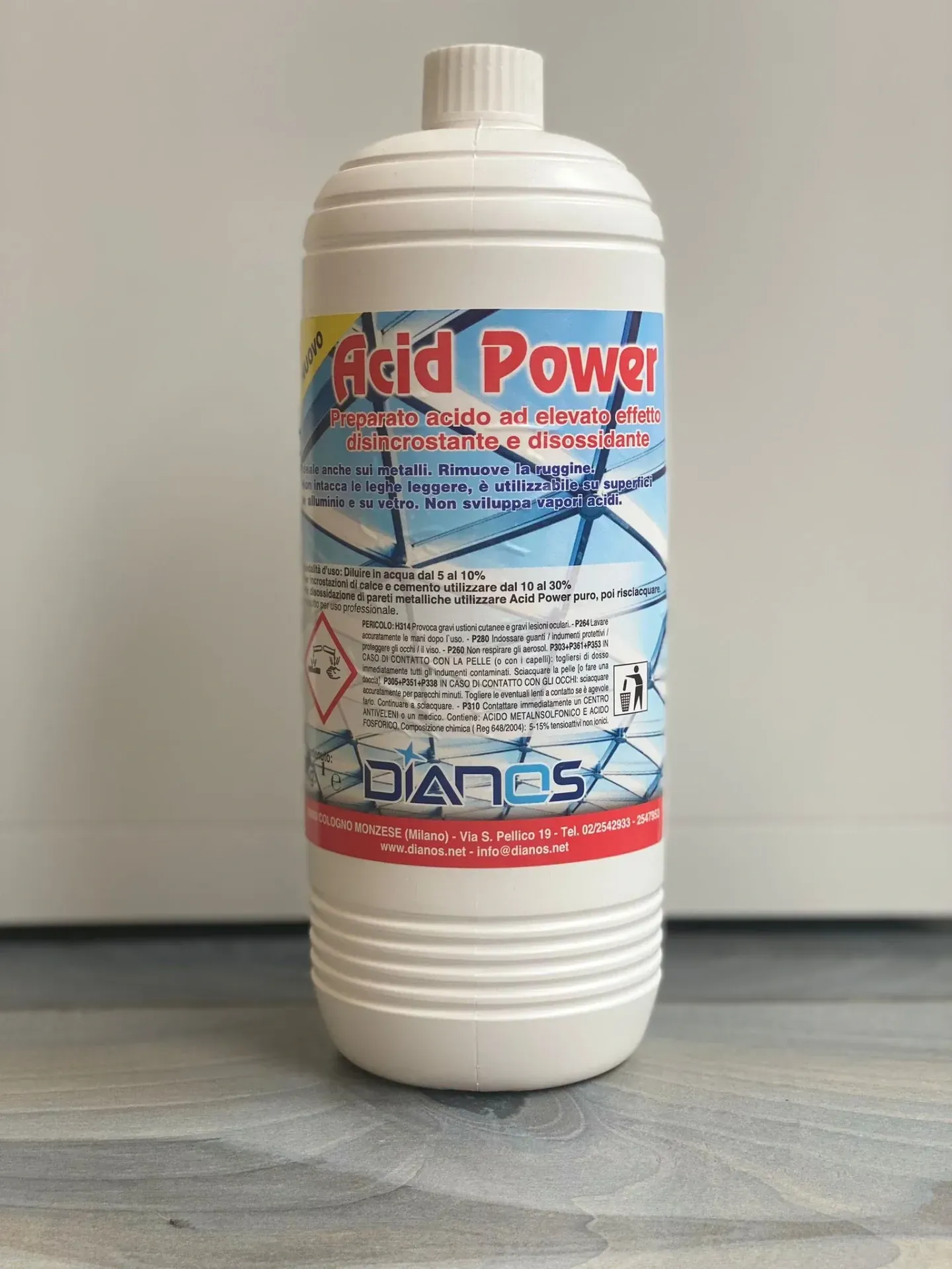 Flacone di plastica bianca contenente un detergente acido ad alta potenza con etichetta blu-rossa su sfondo grigio.