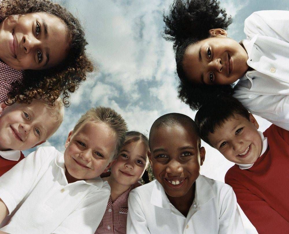 A group of children are posing for a picture together.