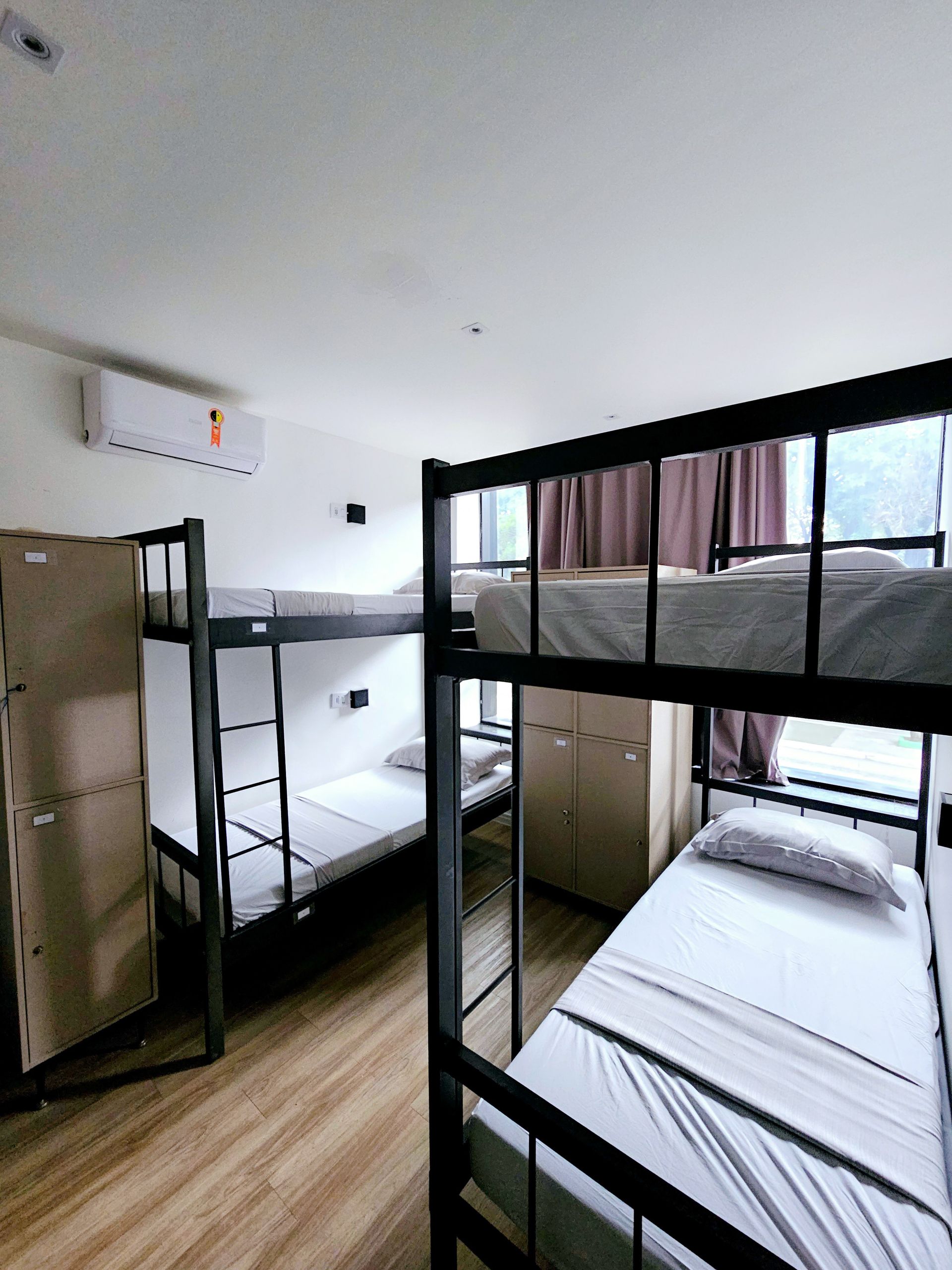 A room with four bunk beds and a window