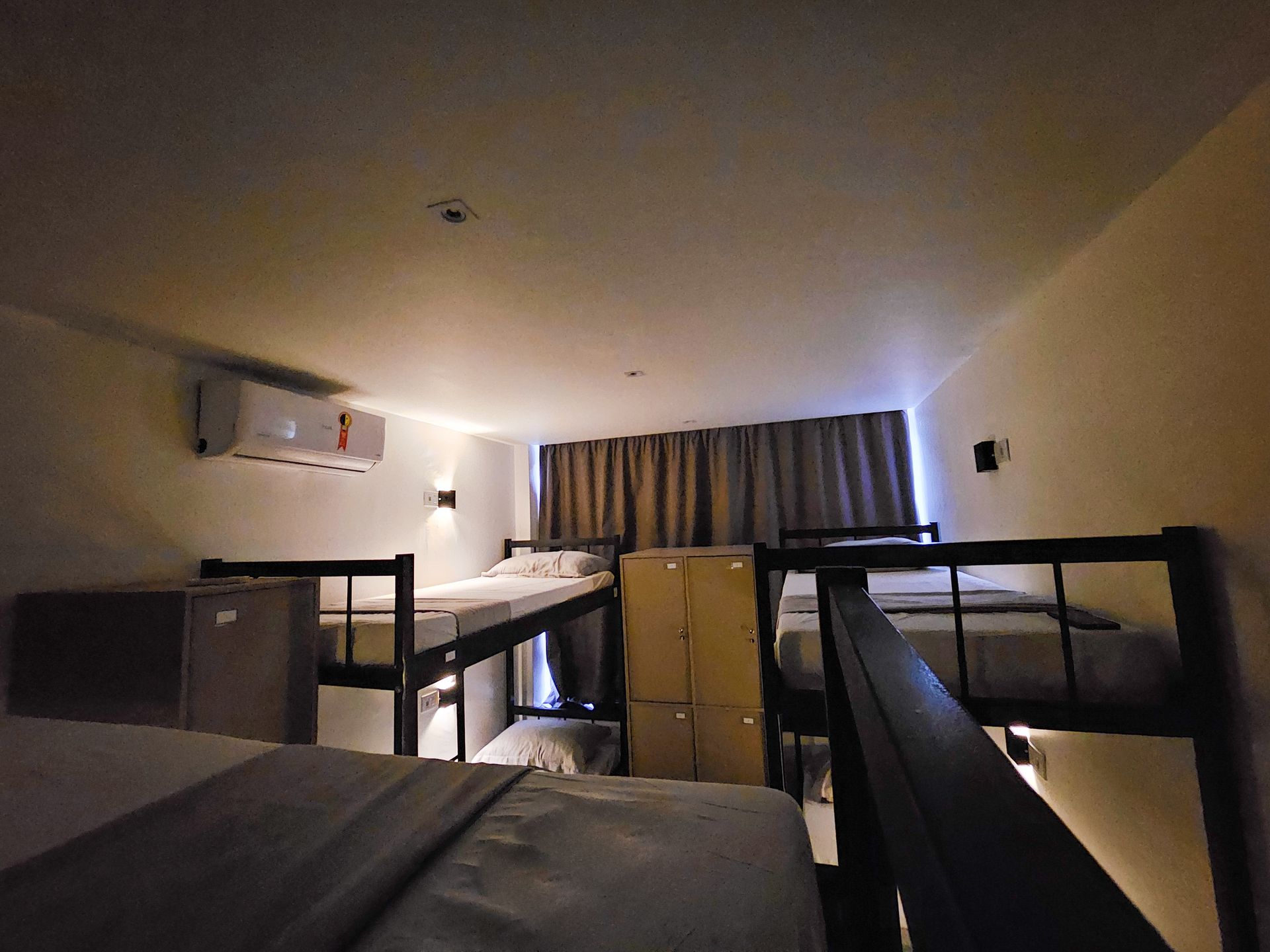 A room with bunk beds and lockers in it