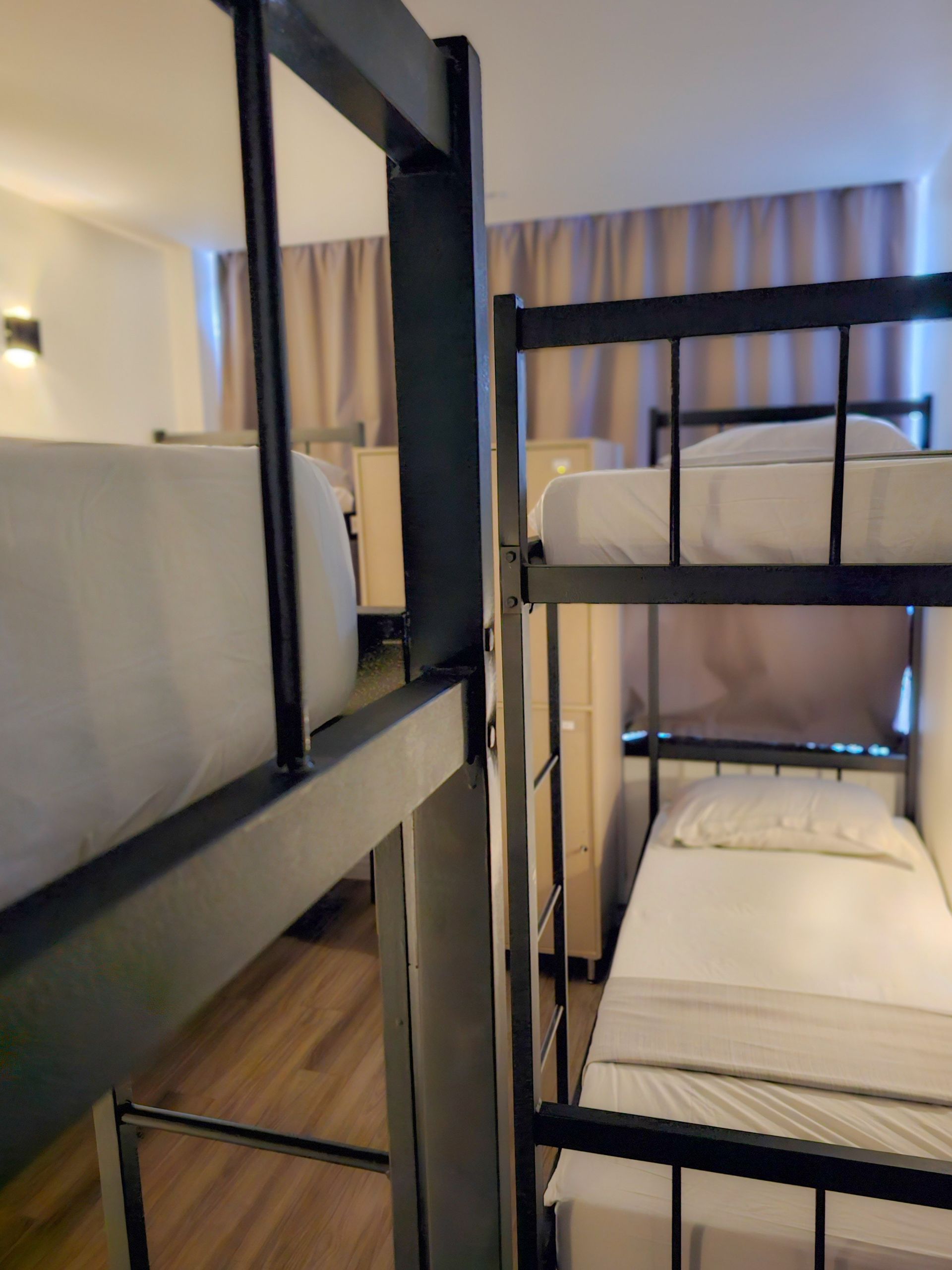 A room with two bunk beds and two single beds