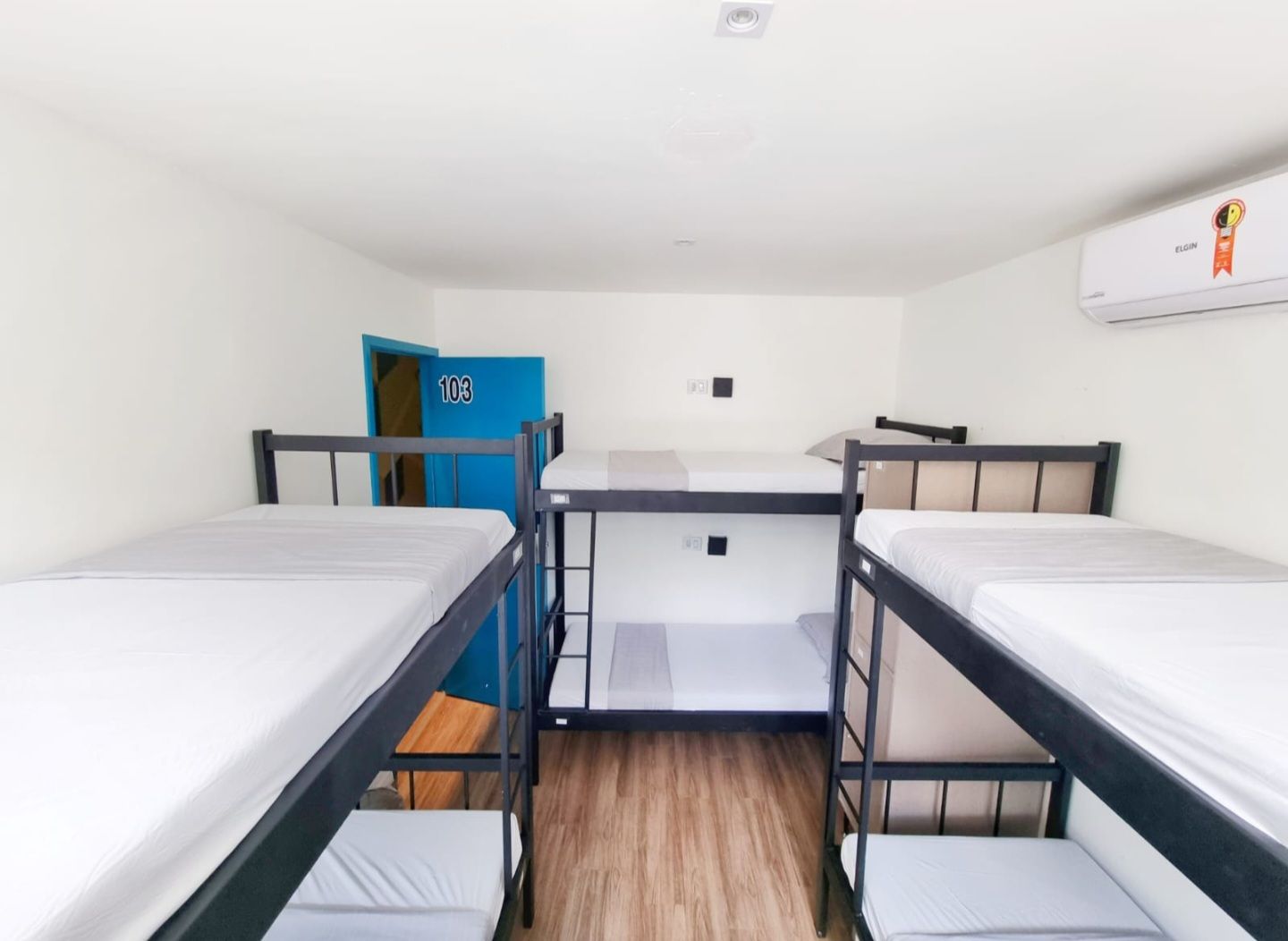 A room with bunk beds and a blue door