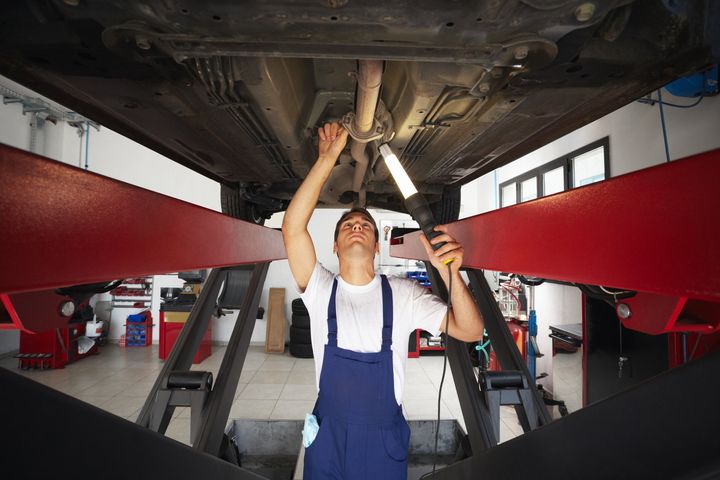Man Fixing Car | Lincoln, NE | Hanquist Service Man Fixing Car | Lincoln, NE | Hanquist Service