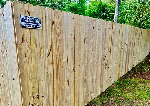 Wooden fence with scalloped top, 