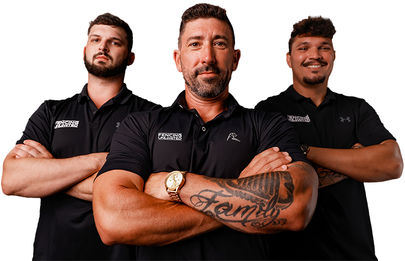Three men in black shirts with arms crossed, smiling.