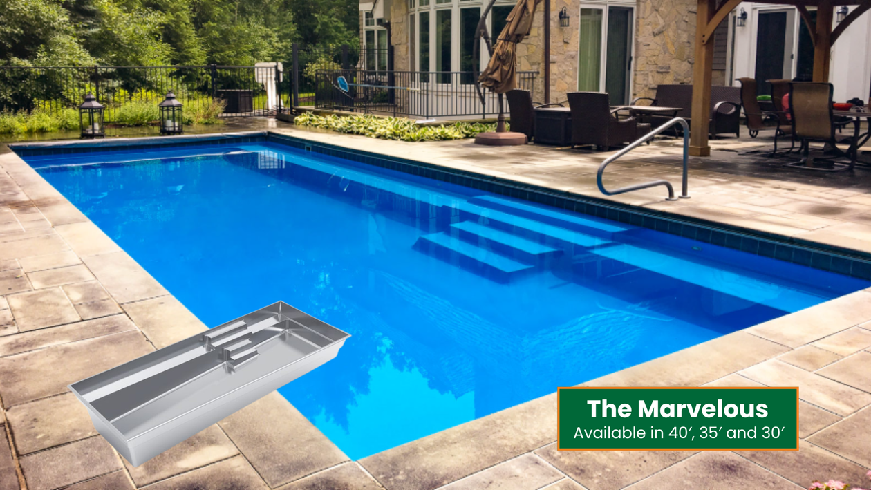 Blue rectangular swimming pool with a silver diving board and patio furniture beside a house