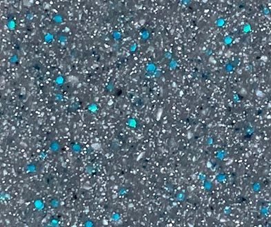 Gray textured surface with scattered bright blue specks like confetti or granules