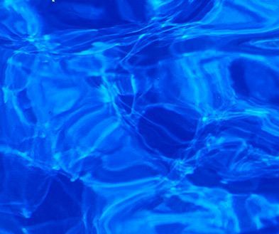 Blue rippling water with shimmering light reflections