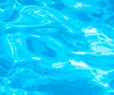 Bright turquoise water with sunlit ripples and gentle waves