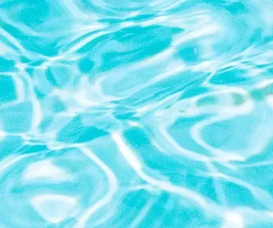 Light blue rippling water surface with bright sunlit reflections