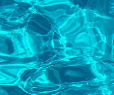 Blue pool water with bright rippling reflections