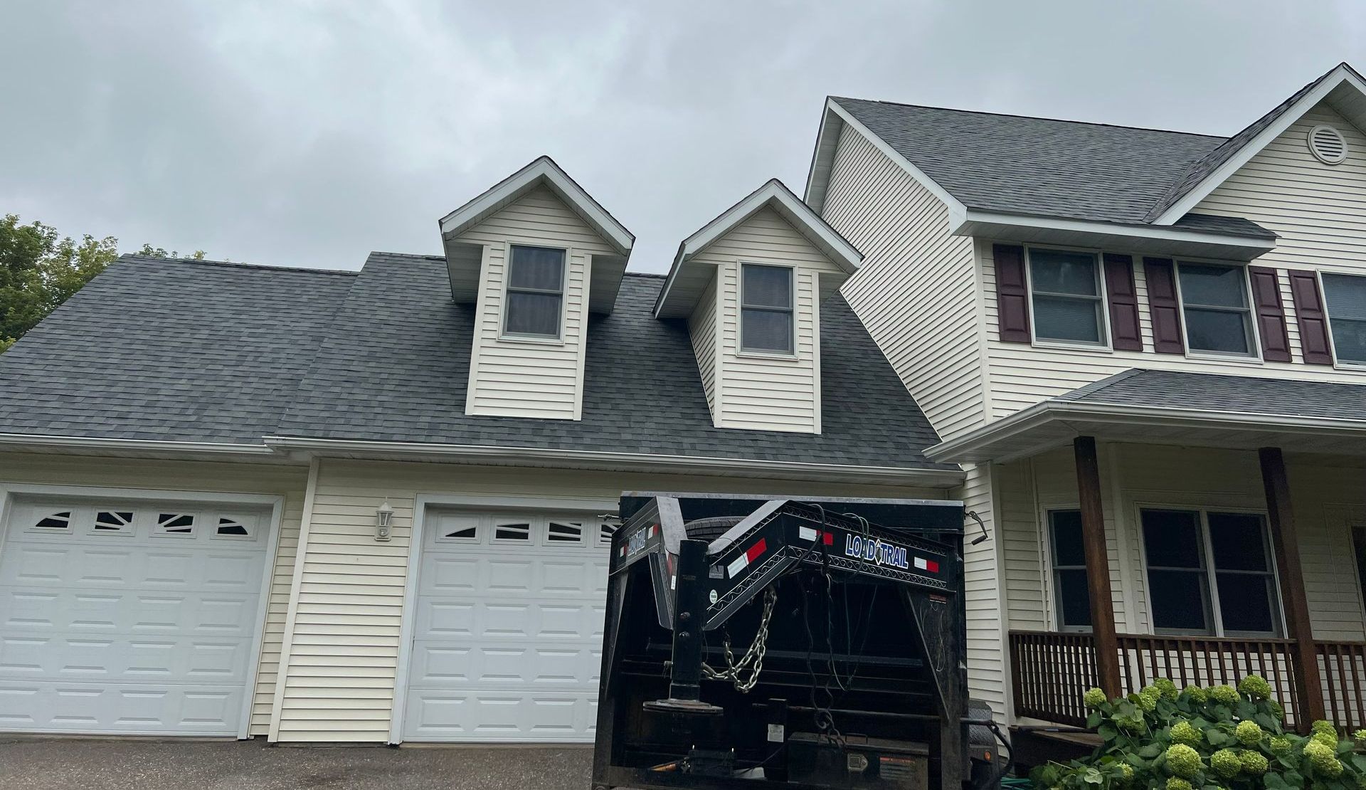 Man Cleaning Gutter Of The Roof | New Richmond, WI | DC Roofing Inc. Man Cleaning Gutter Of The Roof | New Richmond, WI | DC Roofing Inc.