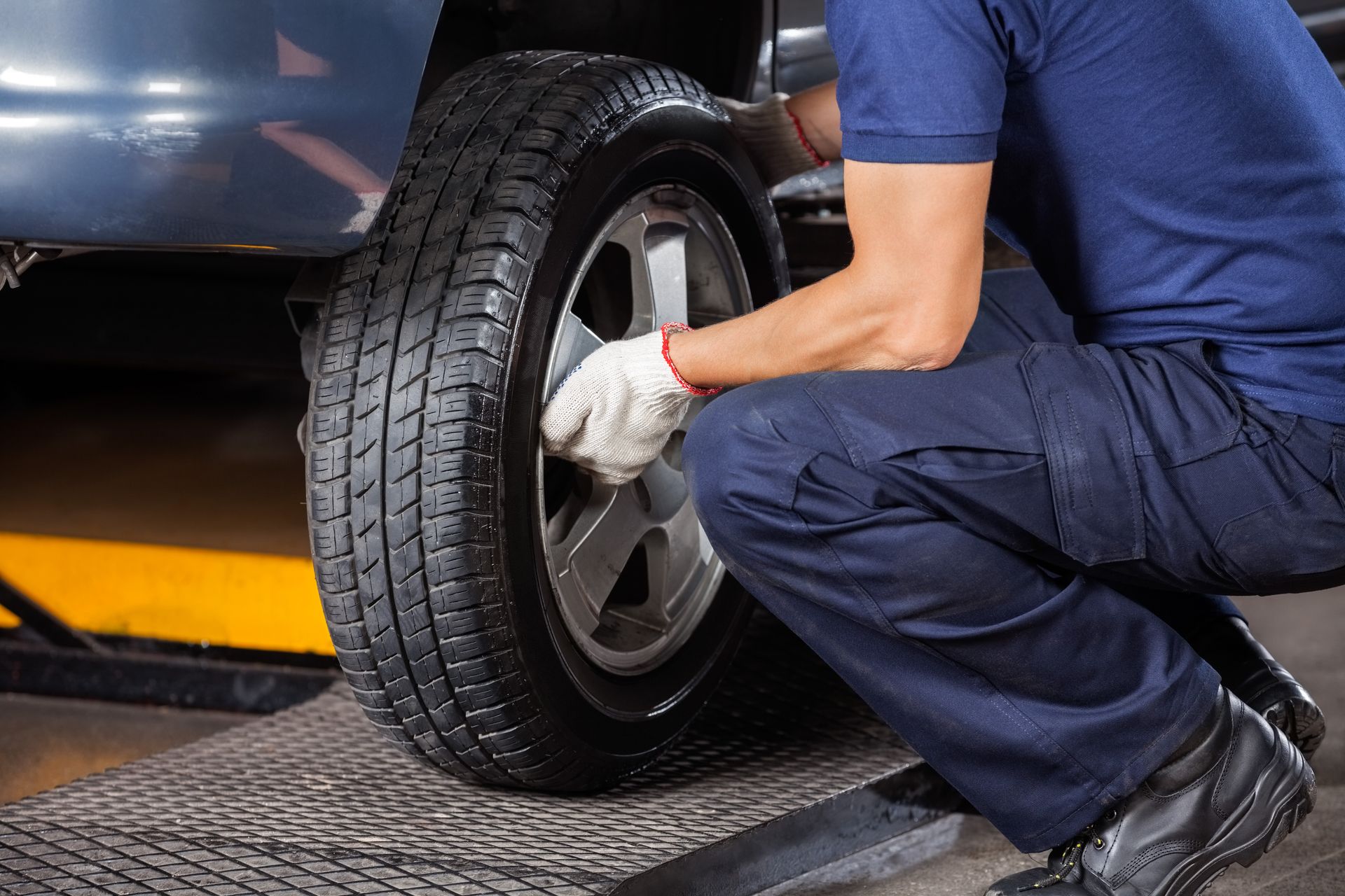A Technician Replacing Tire | Suburban Tire Auto Repair Centers