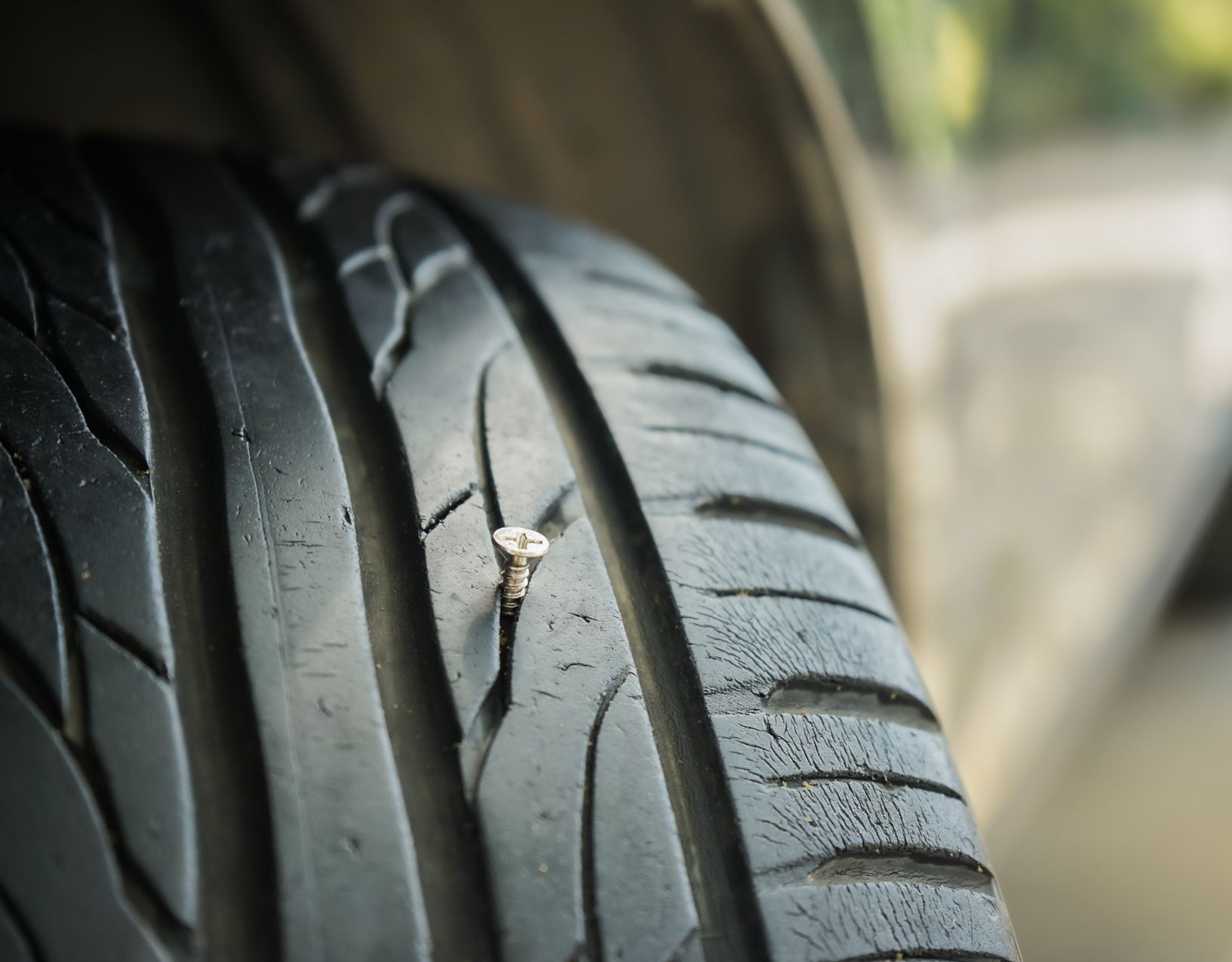 A close up of a tire with a screw in it | Suburban Tire Auto Repair Centers