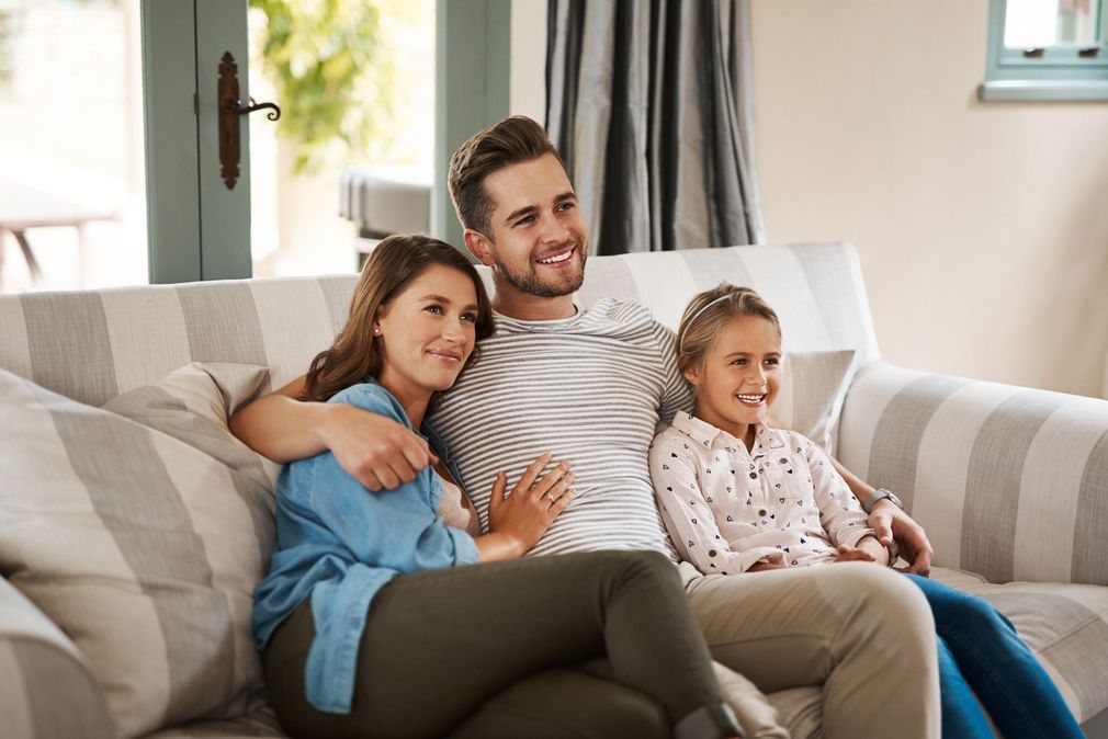 Comfortable family relaxing at home with reliable HVAC service from The Flexline