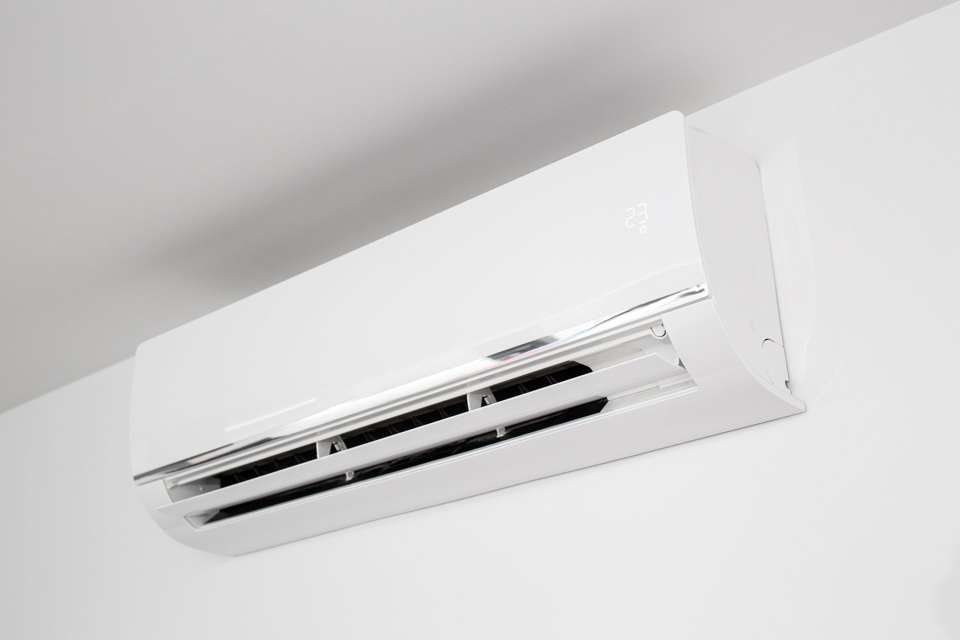 White wall-mounted split air conditioner on a light gray wall