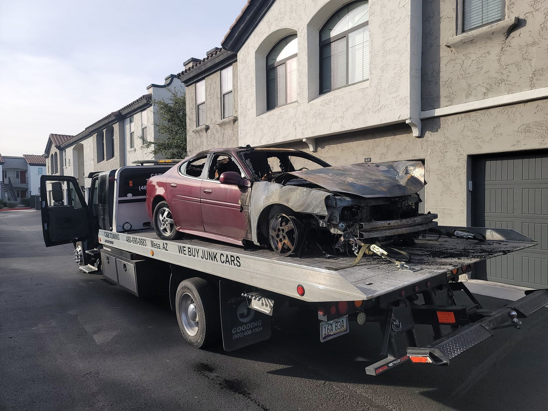 A tow truck with a car on the back of it