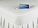 A can of soda is sitting on top of a white mattress protector. A can of soda is sitting on top of a white mattress protector.