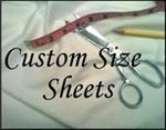 A pair of scissors sitting on top of a piece of fabric next to a measuring tape. A pair of scissors sitting on top of a piece of fabric next to a measuring tape.