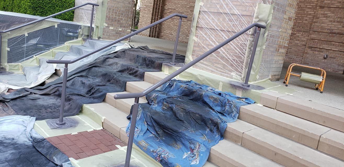Staircase under construction, with protective coverings and handrails.