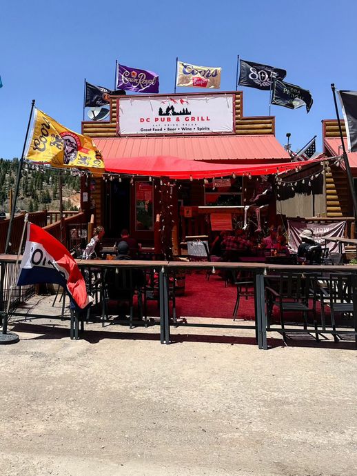 A restaurant with a lot of flags on top of it