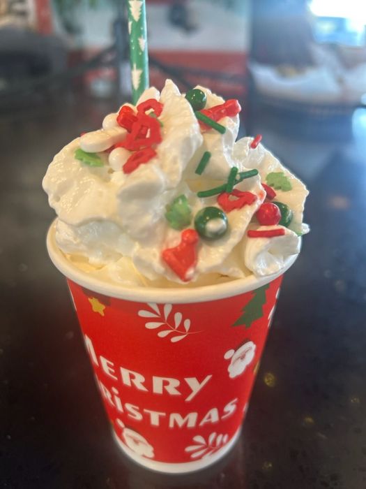 A cup that says merry christmas on it